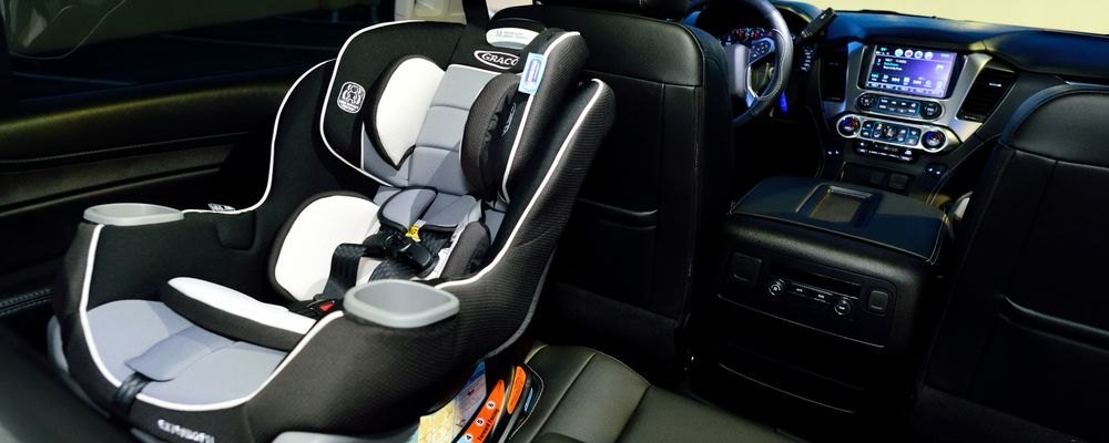 Empty child safety seat installed in the rear seat of a vehicle