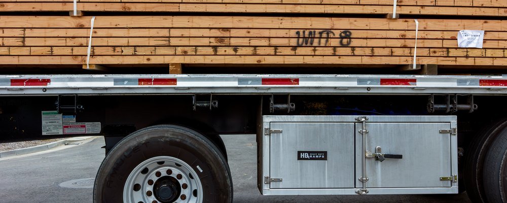 Stack of lumber strapped down on a flatbed trailer